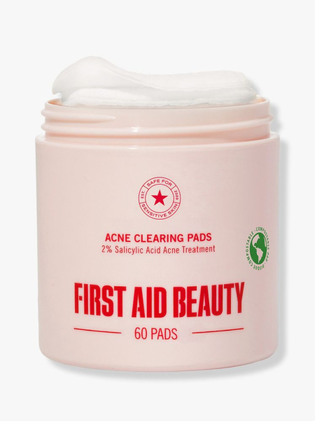 First Aid Beauty Acne Clearing Pads pink jar on light gray background